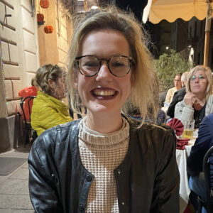 A very smiley Alice say with a pizza