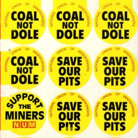 Yellow NUM stickers saying Coal not Dole