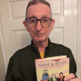 Our Charlie stood holding his dogeared hardback book United By The Struggle by Anne and Betty