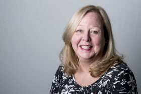 A smiling Karen Reay with shoulder length blonde hair