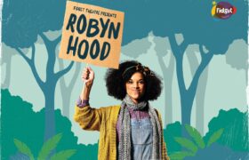 A young woman with an illustrated forest behind holding a homemade sign saying Robyn Hood