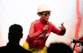 A construction worker in shades rapping
