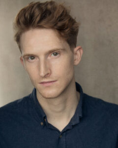 Bay headshot with short strawberry blond hair