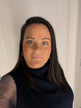 A selfie of Coralie in a black top