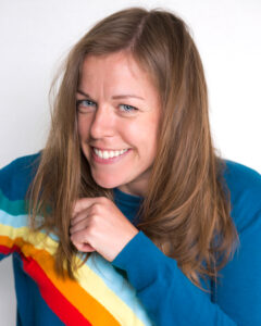 Kathryn in a bright rainbow jumper