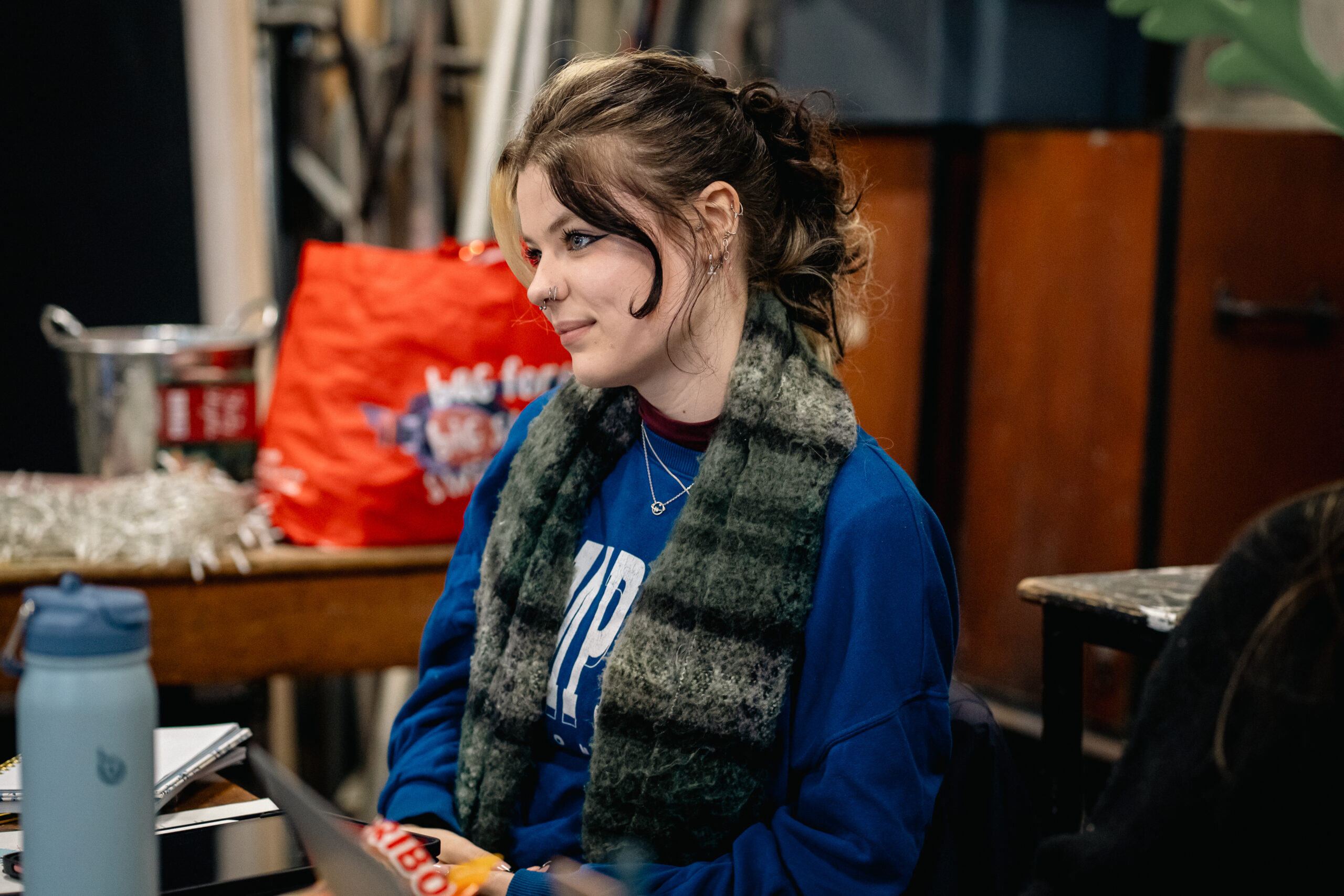 A young woman sat with her head tilted to one side
