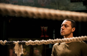 A man looking pensive in a wrestling ring