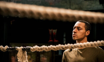 A man looking pensive in a wrestling ring