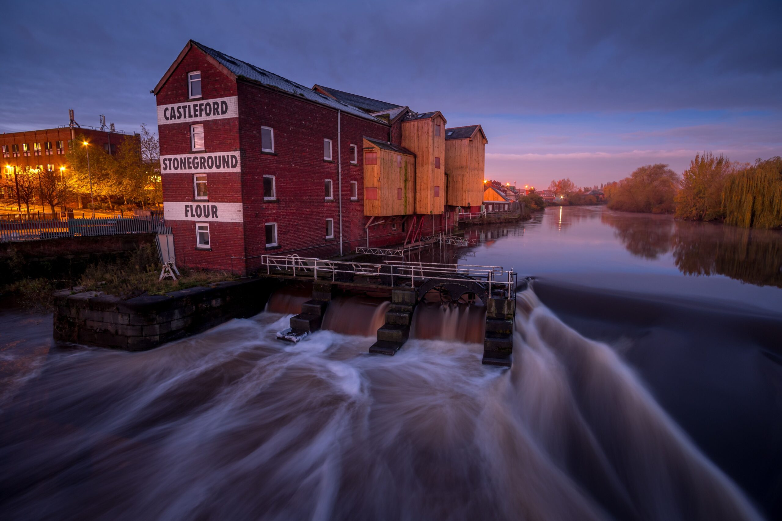 Queen's Mill flour mill on the river Aire at sunset